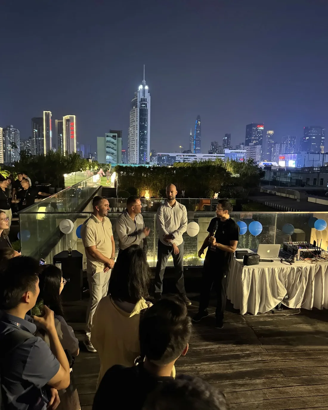 Conference opening party on a rooftop with a view of Shenzhen at night